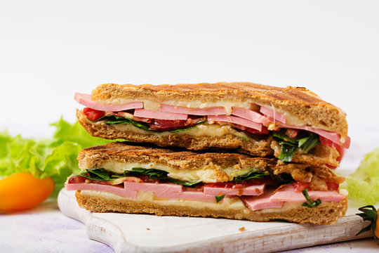 Club sandwich panini with ham, tomato, cheese and lettuce