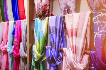 Colored silk scarfs in rows in shop