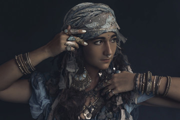 gypsy style young woman wearing tribal jewellery portrait