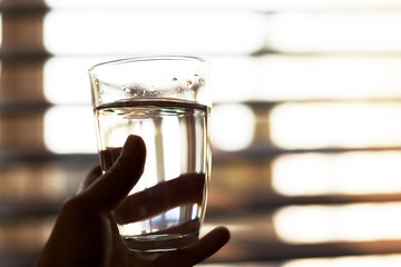 Woman holding a glass of water, close-up