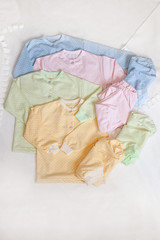 Set of baby clothes for pastel tones on the white background
