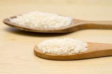 wooden spoons with rice on the table