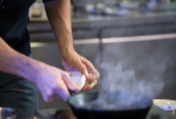 Hands of the cook during the preparation of the product