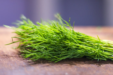 green dill on cutting desk soft focus
