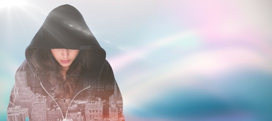 Composite image of female hacker in black hoodie