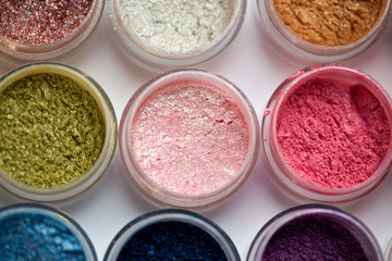 Cosmetics. Pigments for make-up, eyes, lips, face and body. Brilliant radiant, scattered multicolored powders.