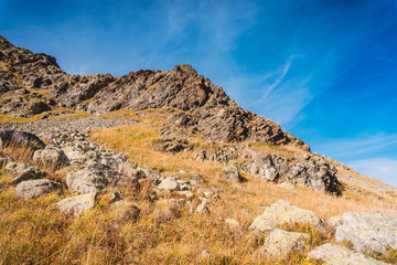 Autumn in mountains. Rocky mountains with stones.