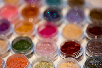 Cosmetics. Pigments for make-up, eyes, lips, face and body. Brilliant radiant, scattered multicolored powders.