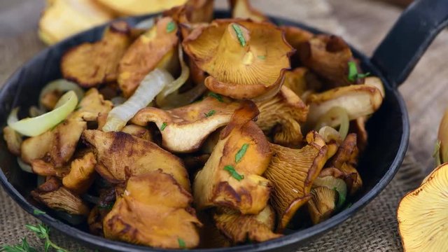 Portion of rotating fried Chanterelles (in a pan) as 4K UHD footage (not loopable)
