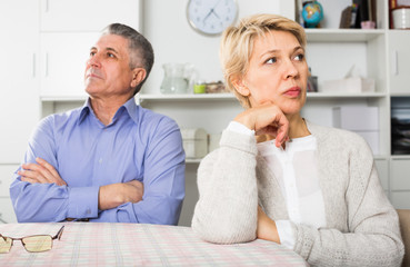 Mature man and woman are offended at each other