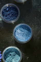 Cosmetics. Pigments for make-up, eyes, lips, face and body. Brilliant radiant, scattered multicolored powders.