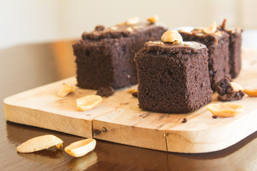 Shock Chocolate brownies with nuts on a wooden floor. 