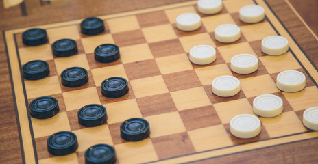 Obraz na płótnie Canvas Vintage wooden chess on the chess board closeup