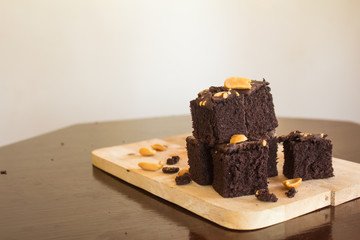 Shock Chocolate brownies with nuts on a wooden floor. 