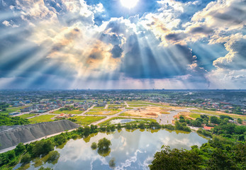 Landscape afternoon in a small town with sun rays through the clouds seen from above as beautiful paintings