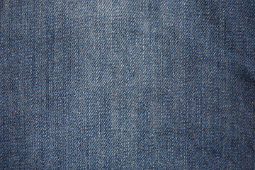 Naklejka premium Used old blue jeans fabric closeup shot, abstract texture