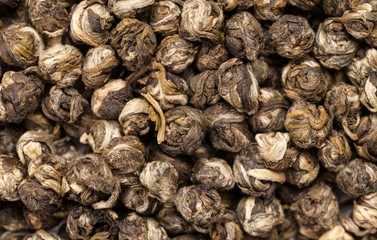 Dry green tea balls macro shot, abstract texture