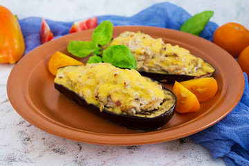 Stuffed eggplant with chicken and vegetables on white background