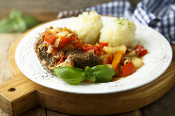 Meat served with vegetable stew and potato dumplings