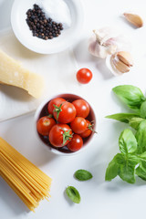fresh tomatoes, herbs and spices on white background.