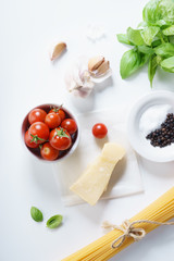 fresh tomatoes, herbs and spices on white background.