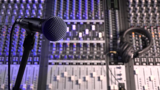 Microphone and Headphones on dirty sound mixer panel
