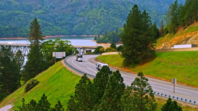 Vehicles driving on Pit River Bridge double deck road and rail bridge over Shasta Lake in Shasta County, California, with Interstate 5 on upper and Union Pacific Railroad on lower deck