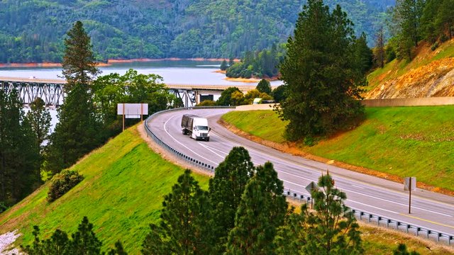 Vehicles driving on Pit River Bridge double deck road and rail bridge over Shasta Lake in Shasta County, California, with Interstate 5 on upper and Union Pacific Railroad on lower deck