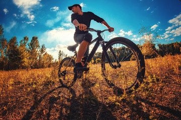 Obraz na płótnie Canvas Young athletic guy on a sports bike