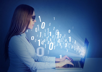 Woman sitting at table working on a laptop learning computer science with binary code coming out of...