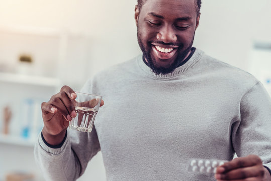 Positive minded African American man taking medication