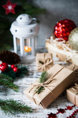 Christmas background. Christmas composition. Christmas gift, pine cones, fir branches on wooden white background.