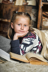 Girl schoolgirl reading book sheltering plaid