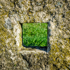 Square hole in an old stone