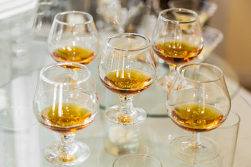 Glasses of cognac and a bottle of some old oak barrels.