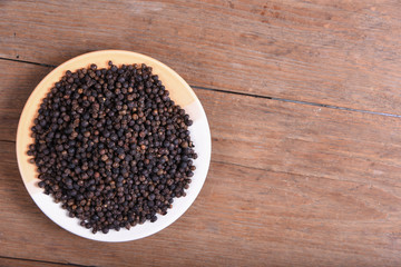 black pepper on old wooden table