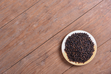 black pepper on old wooden table