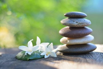 Obraz na płótnie Canvas Zen stones spa with natural green background.