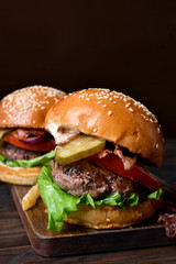Tasty hamburger on wooden board