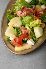 Salad with melon on dish