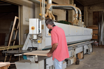 Fototapeta premium a carpenter who is programming a machine
