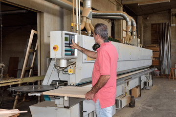 Fototapeta premium a carpenter who is programming a machine