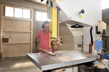 carpenter cutting a wooden board