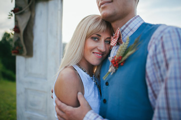 happy couple near wedding frame