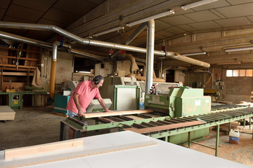 Fototapeta premium carpenter polishing wood in a carpentry workshop