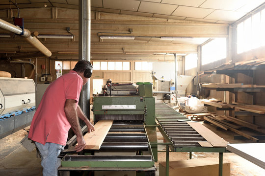 carpenter polishing wood in a carpentry workshop
