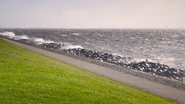 Levee in an October fall storm at the IJsselmeer