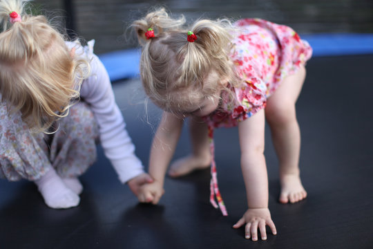 sisters on trampoline, kindergarten, scandinavian child