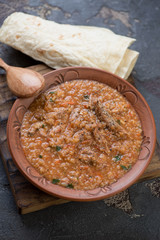 Traditional georgian soup kharcho with meat and rice served in a clay plate, studio shot