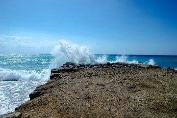 Fototapeta premium Waves break about a stone pier